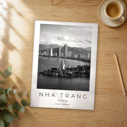 Unframed Nha Trang black and white travel poster on a wooden table