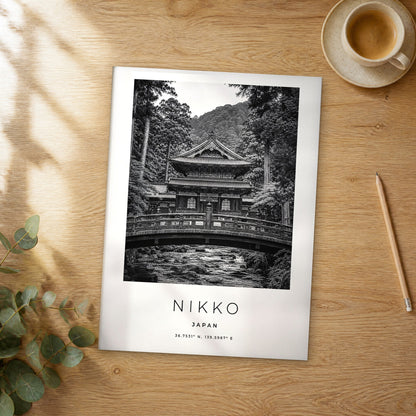 Unframed Nikko black and white travel poster on a wooden table