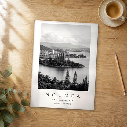 Unframed Noumea black and white travel poster on a wooden table