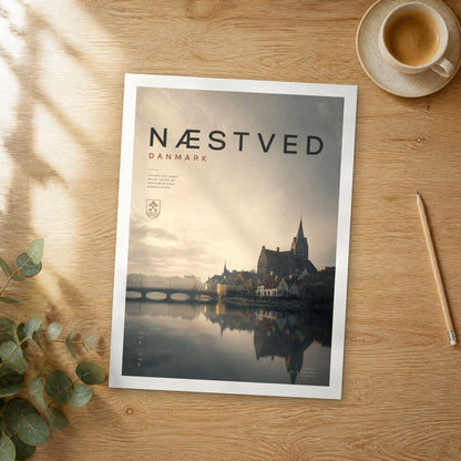 Unframed Næstved bold typography travel poster on a wooden table