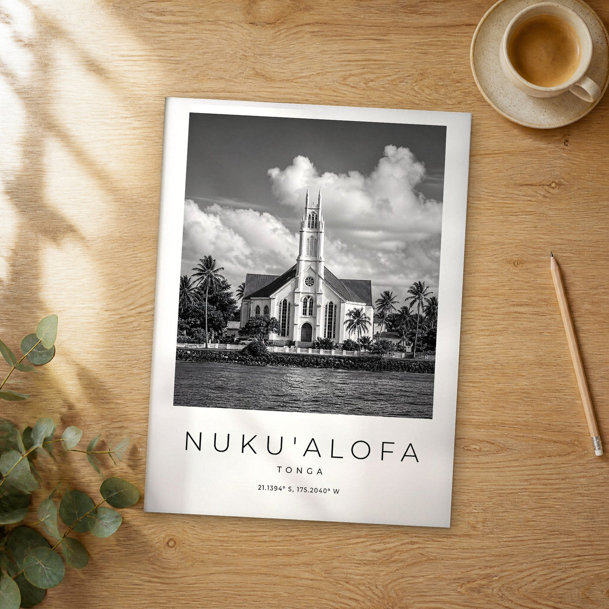 Unframed Nuku'alofa black and white travel poster on a wooden table