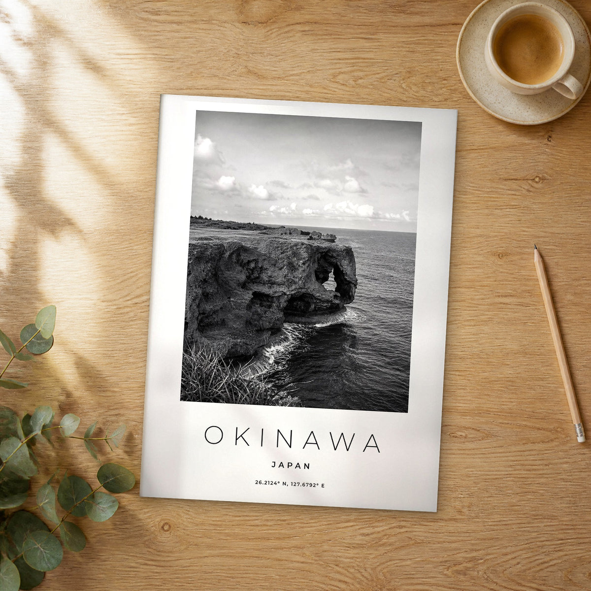 Unframed Okinawa black and white travel poster on a wooden table