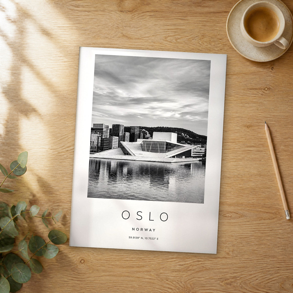 Unframed Oslo black and white travel poster on a wooden table