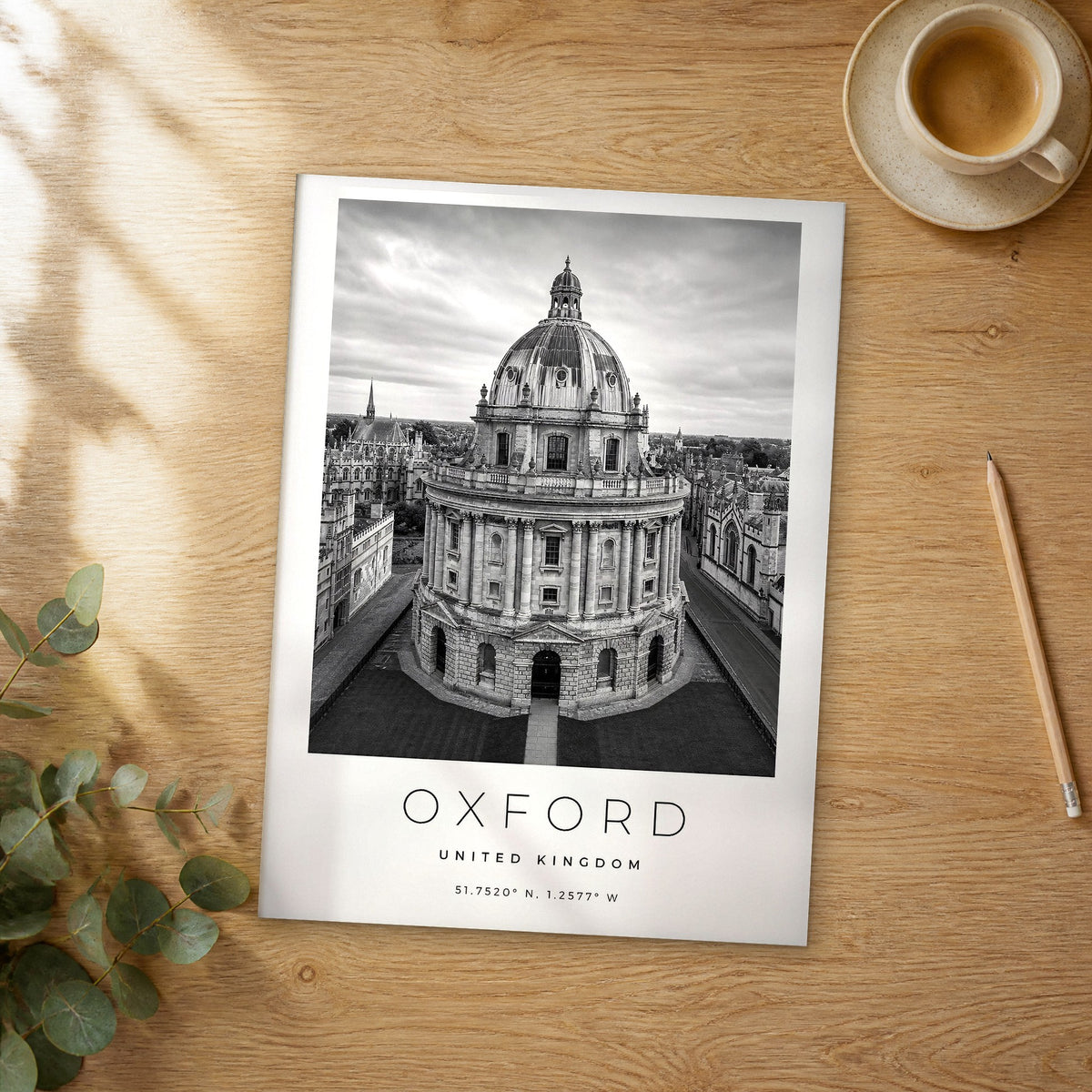 Unframed Oxford black and white travel poster on a wooden table