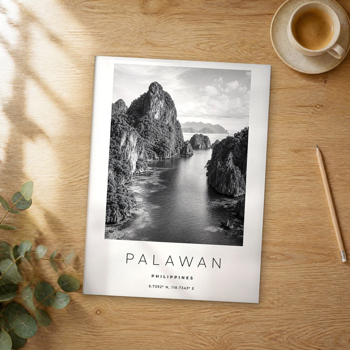 Unframed Palawan black and white travel poster on a wooden table