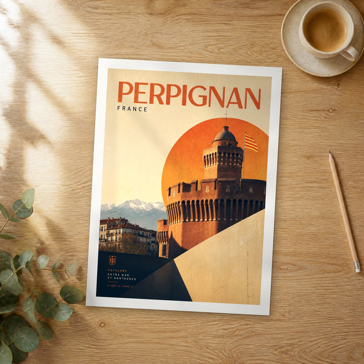 Unframed Perpignan bold typography travel poster on a wooden table