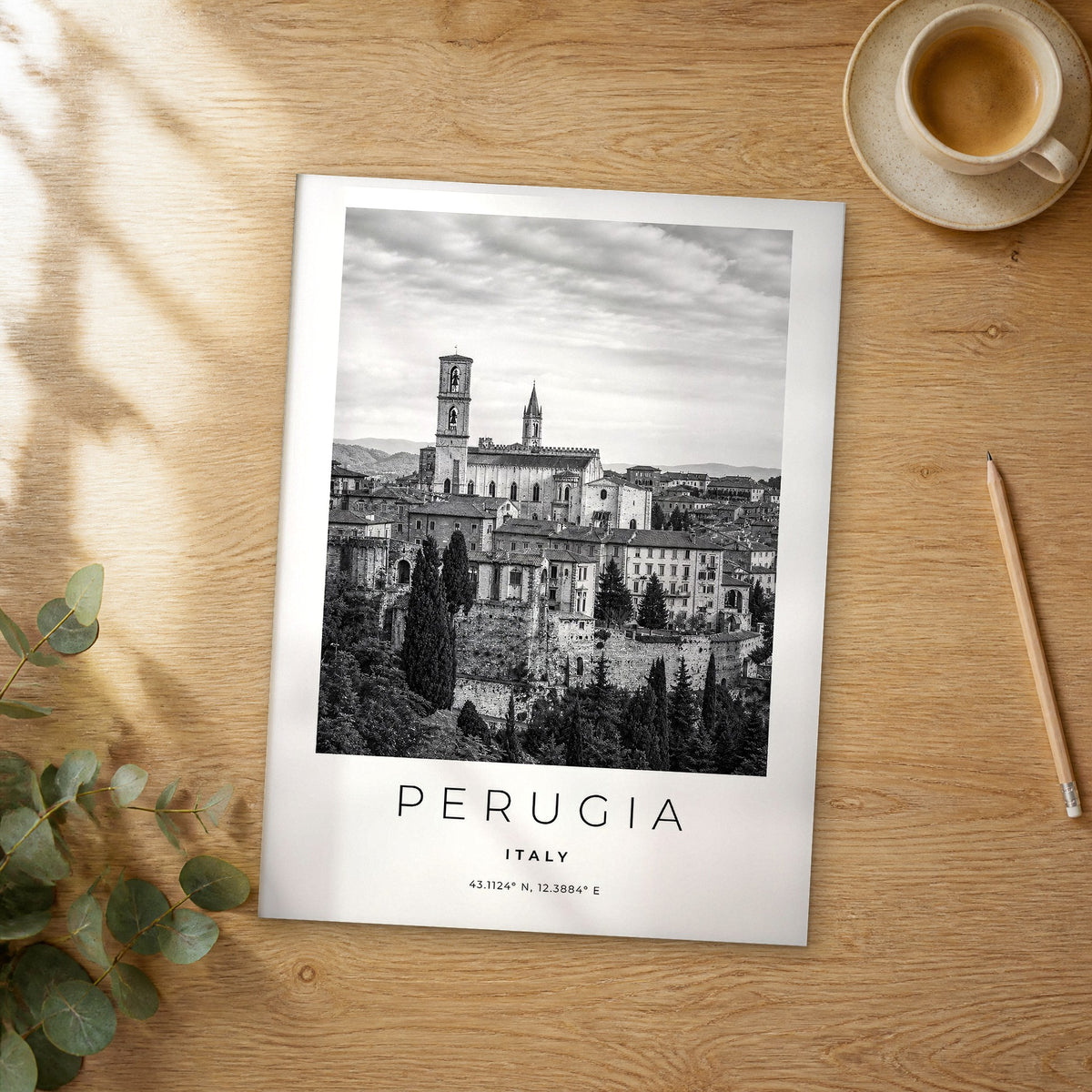 Unframed Perugia black and white travel poster on a wooden table