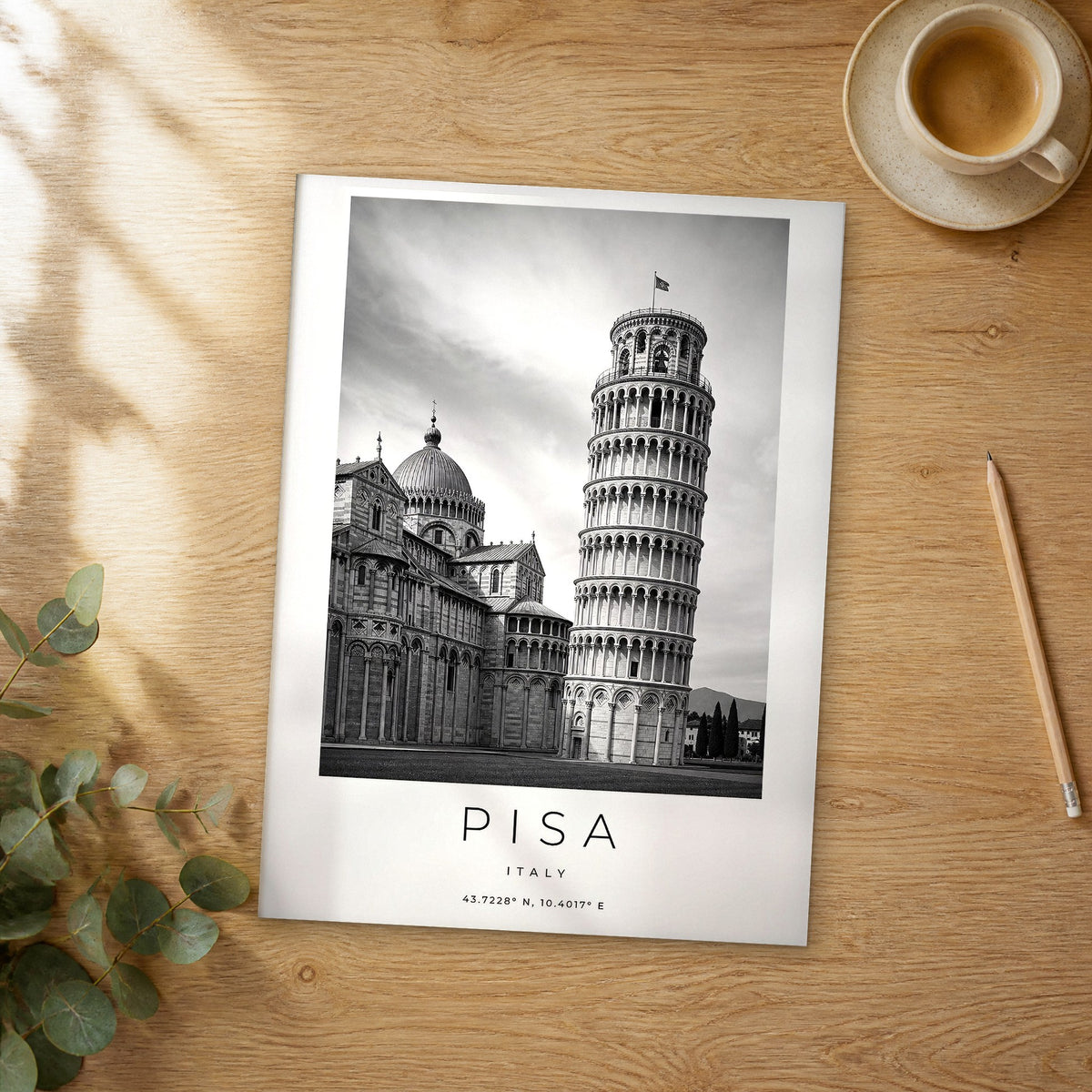 Unframed Pisa black and white travel poster on a wooden table