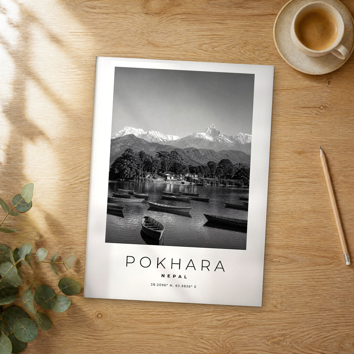Unframed Pokhara black and white travel poster on a wooden table