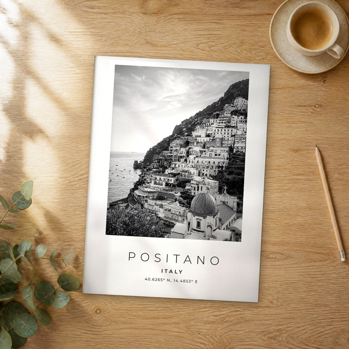 Unframed Positano black and white travel poster on a wooden table