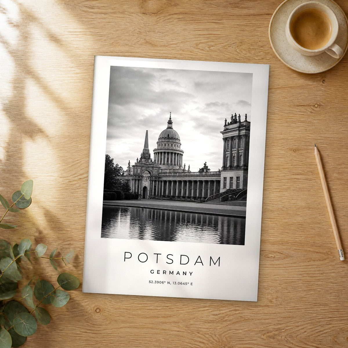 Unframed Potsdam black and white travel poster on a wooden table