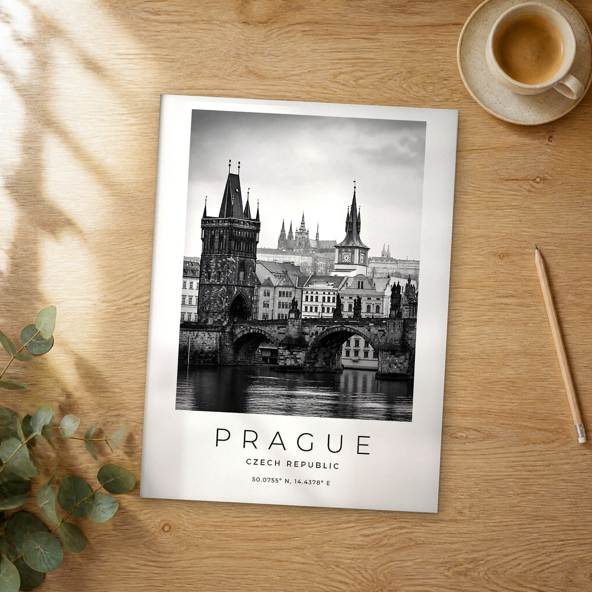 Unframed Prague black and white travel poster on a wooden table