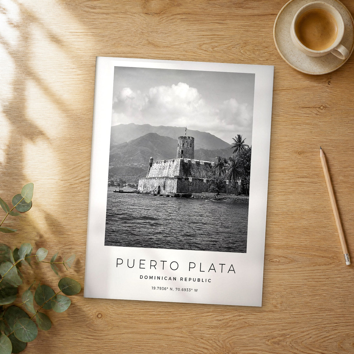 Unframed Puerto Plata black and white travel poster on a wooden table