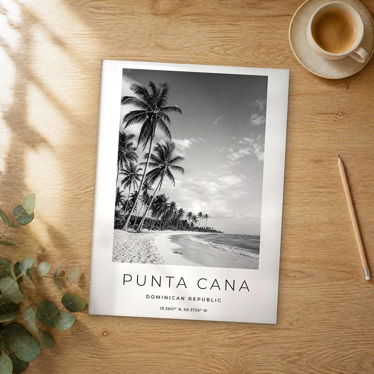 Unframed Punta Cana black and white travel poster on a wooden table