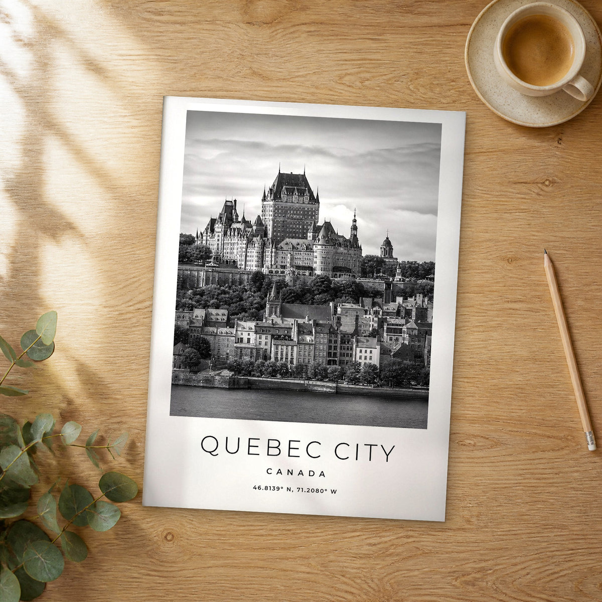 Unframed Quebec City black and white travel poster on a wooden table