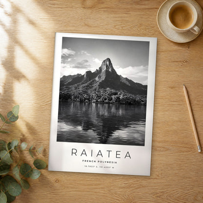 Unframed Raiatea black and white travel poster on a wooden table