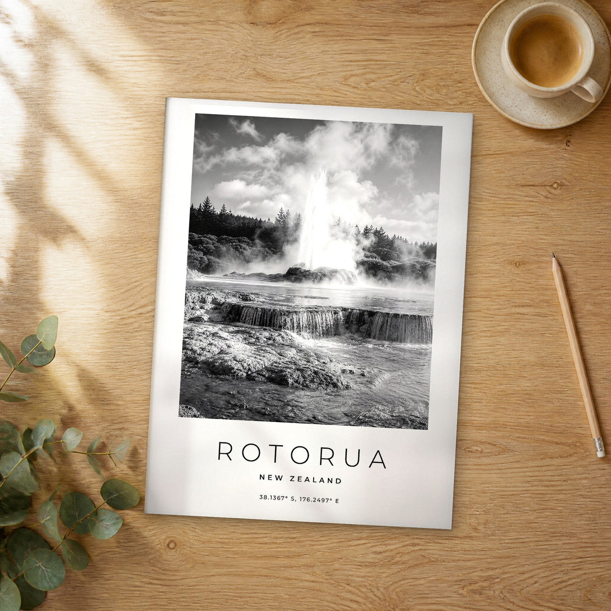 Unframed Rotorua black and white travel poster on a wooden table