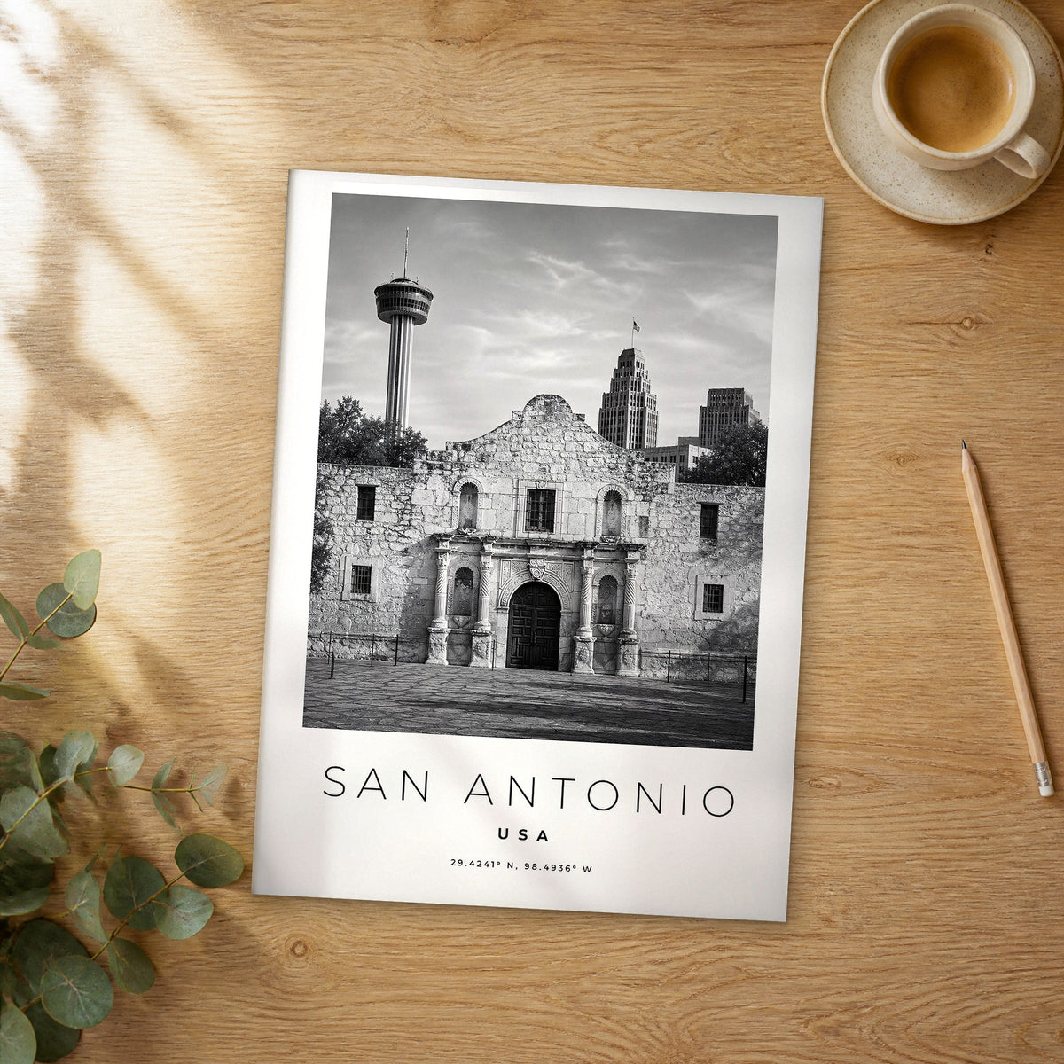 Unframed San Antonio black and white travel poster on a wooden table