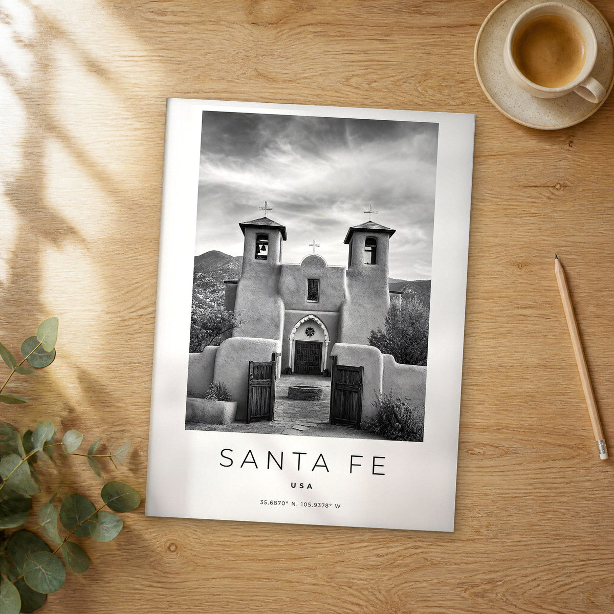 Unframed Santa Fe black and white travel poster on a wooden table