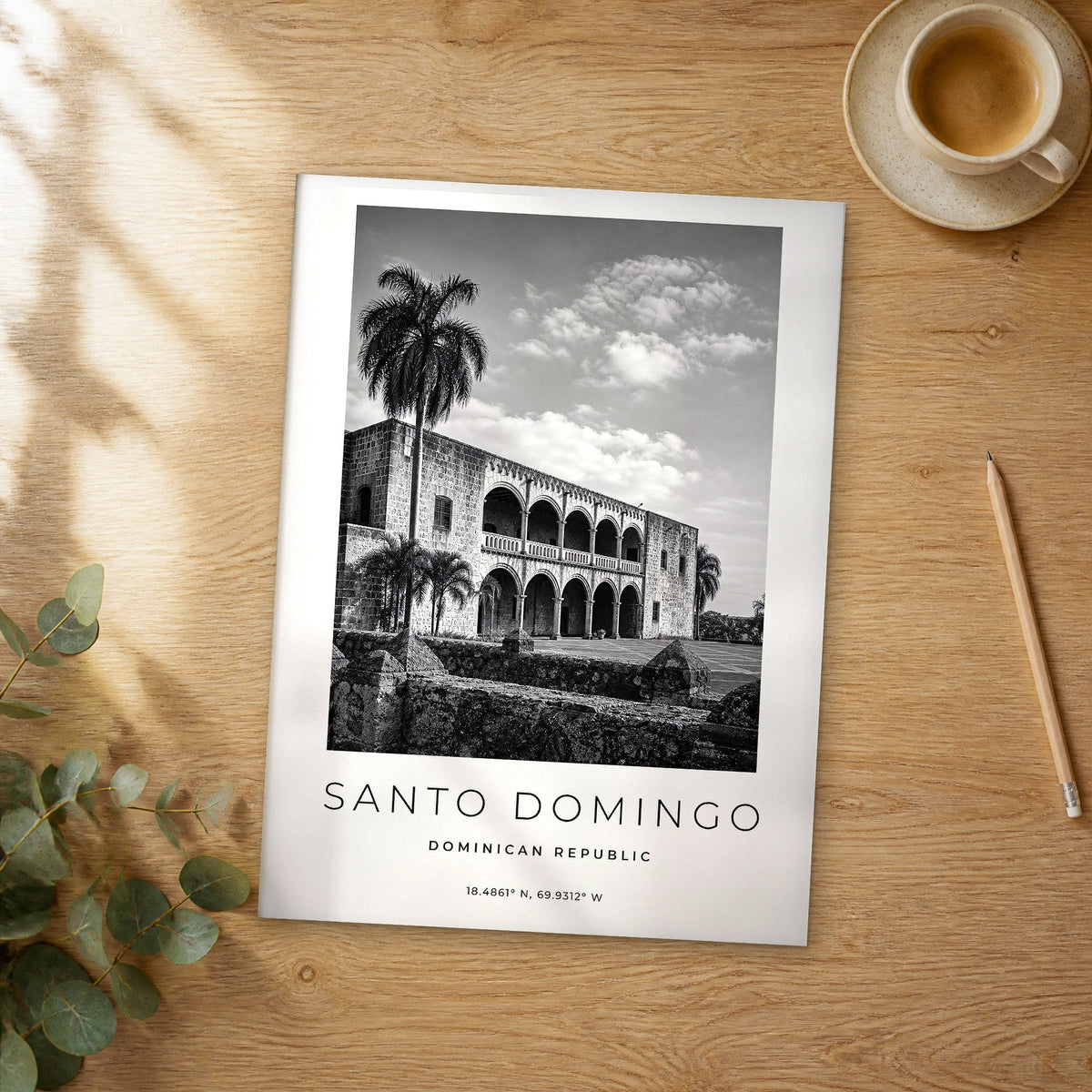 Unframed Santo Domingo black and white travel poster on a wooden table