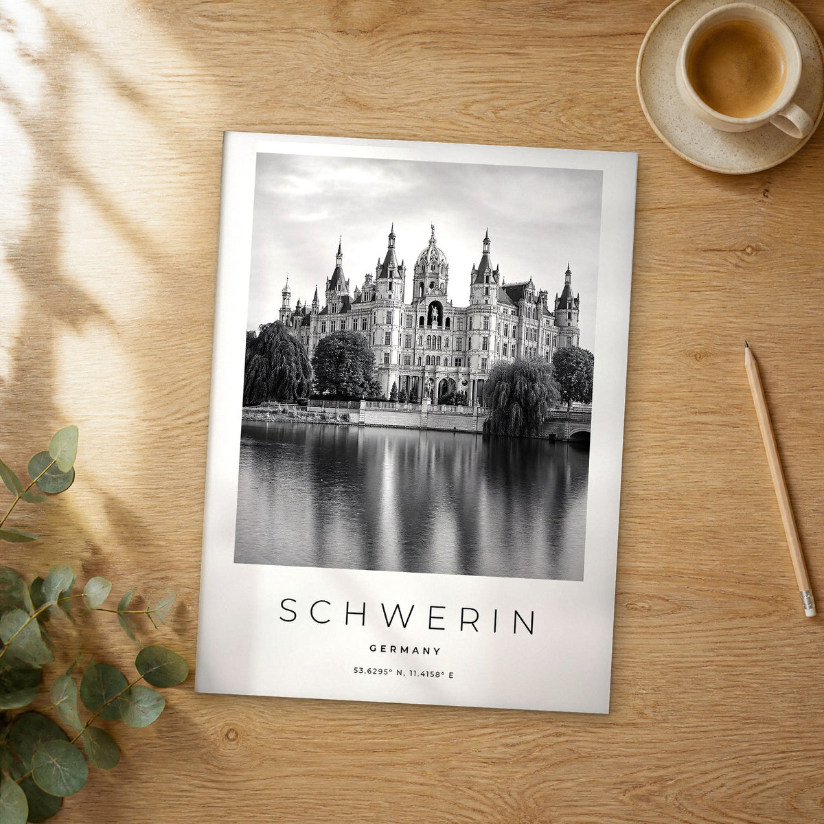 Unframed Schwerin black and white travel poster on a wooden table