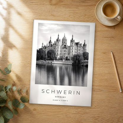 Unframed Schwerin black and white travel poster on a wooden table