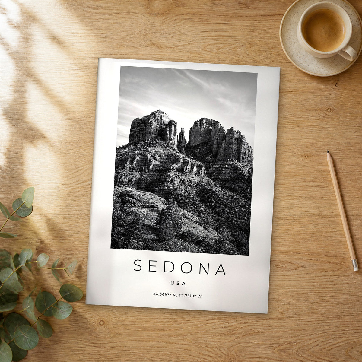 Unframed Sedona black and white travel poster on a wooden table