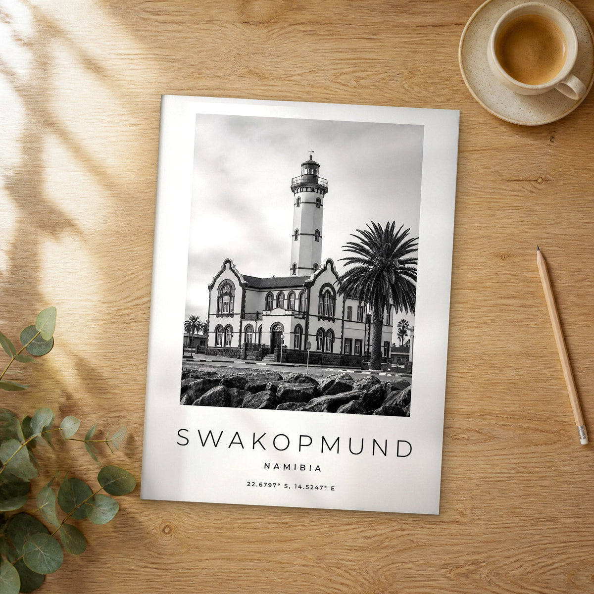Unframed Swakopmund black and white travel poster on a wooden table