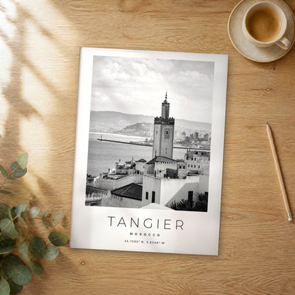 Unframed Tangier black and white travel poster on a wooden table