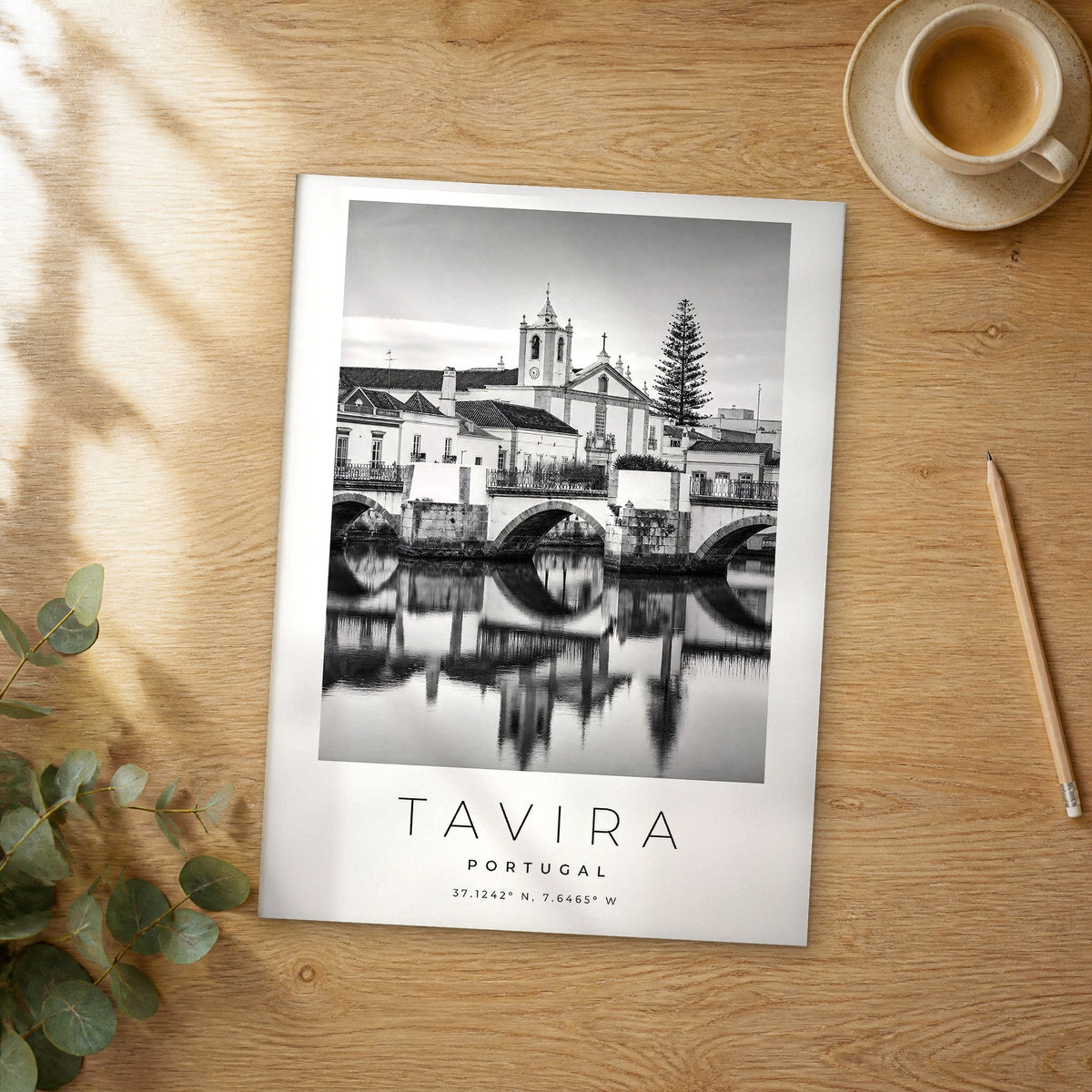 Unframed Tavira black and white travel poster on a wooden table