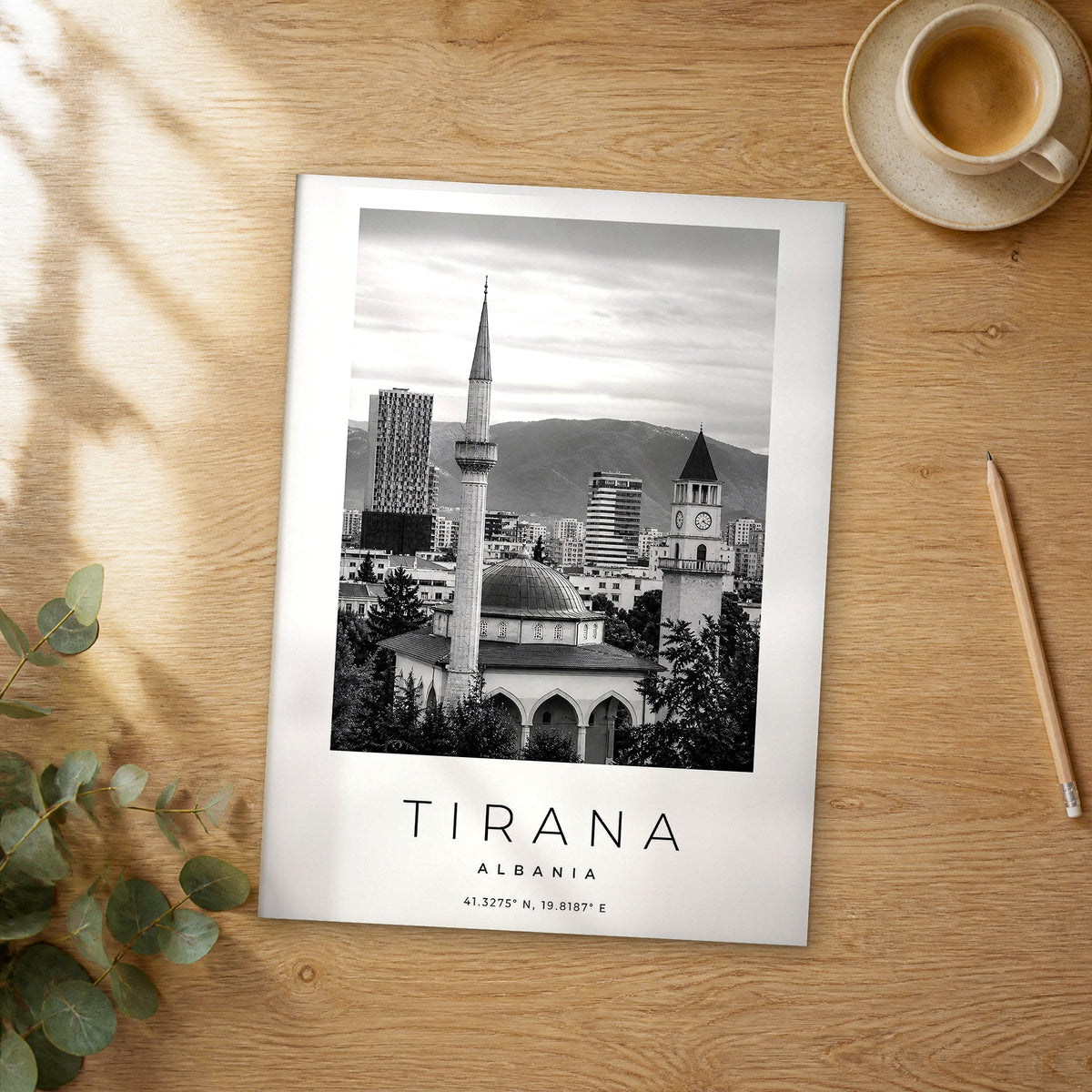 Unframed Tirana black and white travel poster on a wooden table