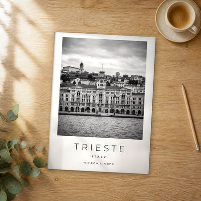 Unframed Trieste black and white travel poster on a wooden table