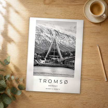 Unframed Tromsø black and white travel poster on a wooden table