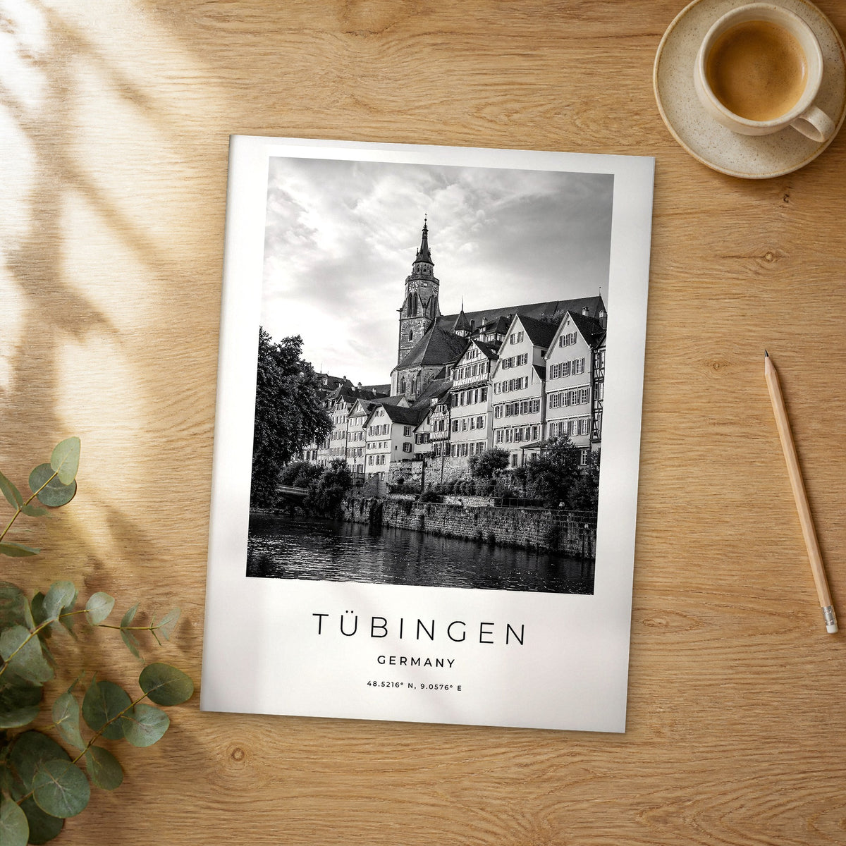 Unframed Tübingen black and white travel poster on a wooden table