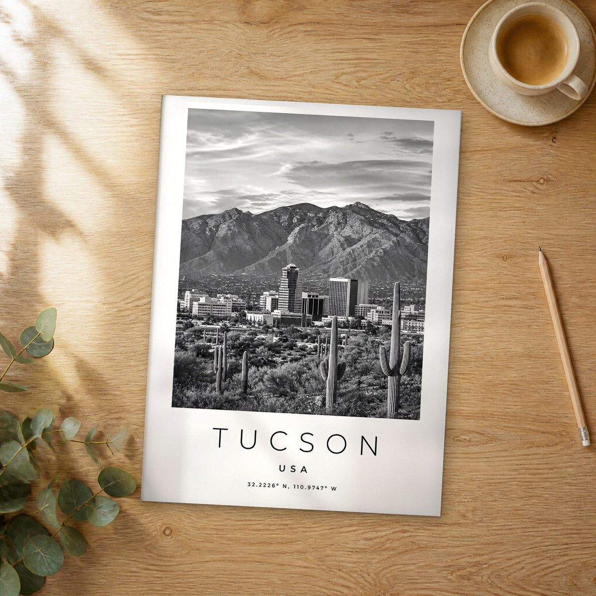Unframed Tucson black and white travel poster on a wooden table