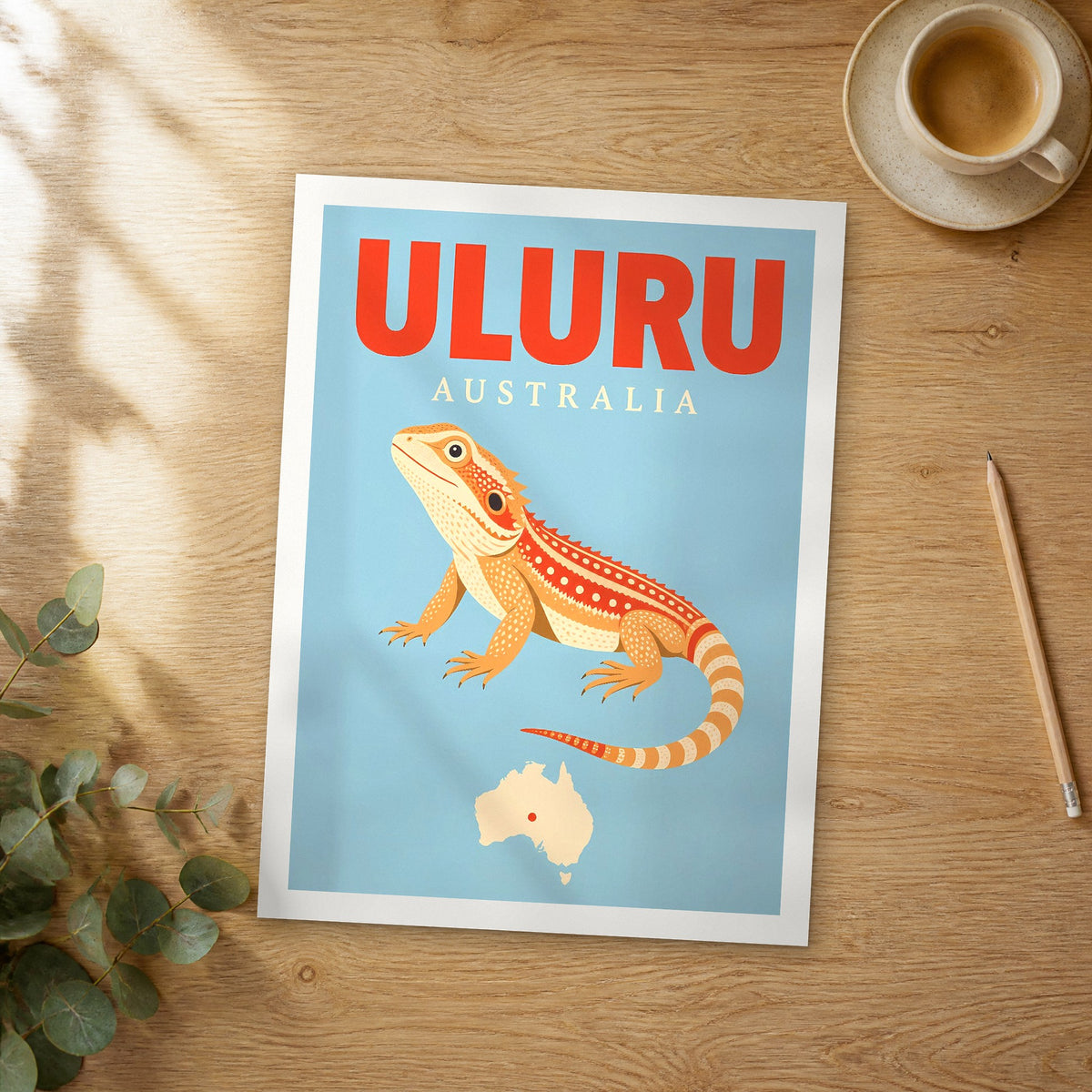 Unframed Uluru pop art travel poster on a wooden table