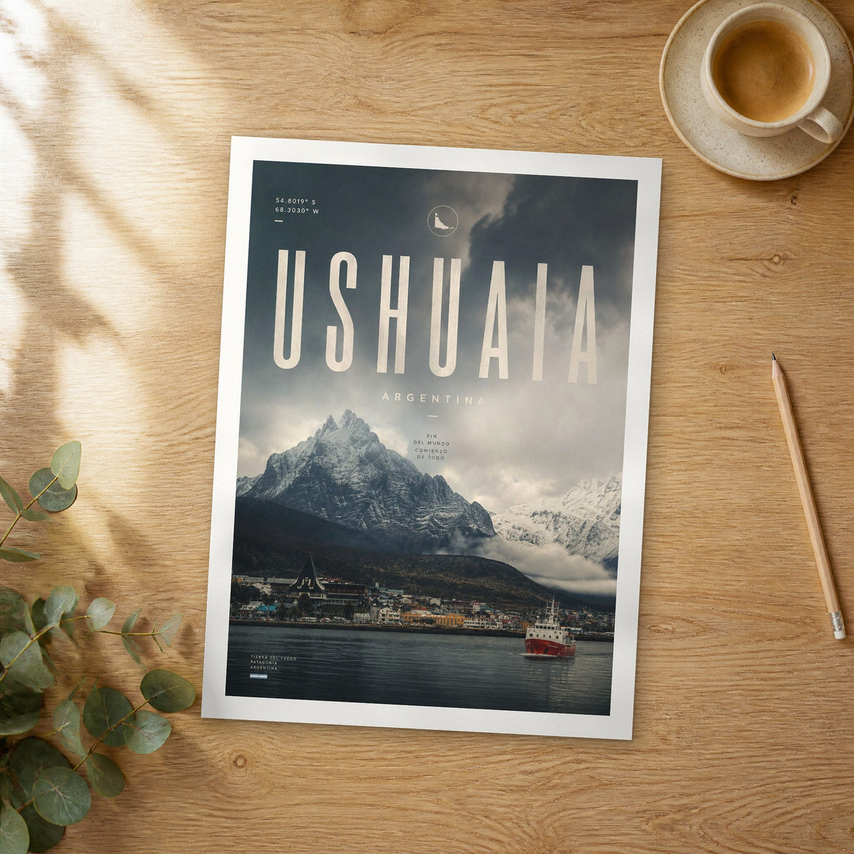 Unframed Ushuaia Harbour with Red Ship bold typography travel poster on a wooden table
