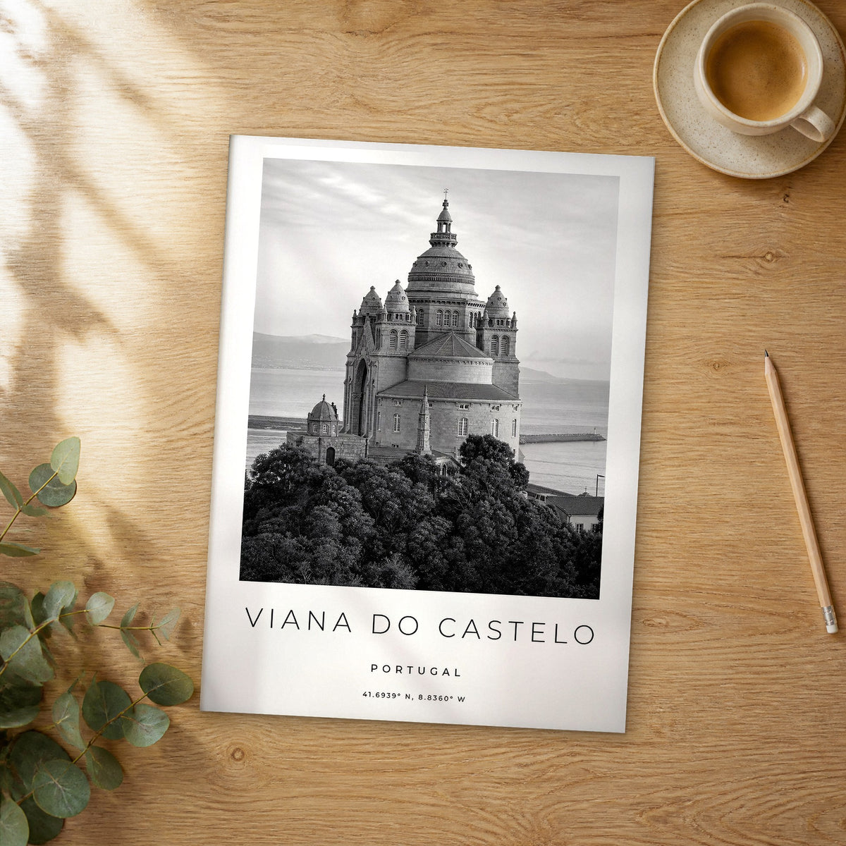 Unframed Viana do Castelo black and white travel poster on a wooden table