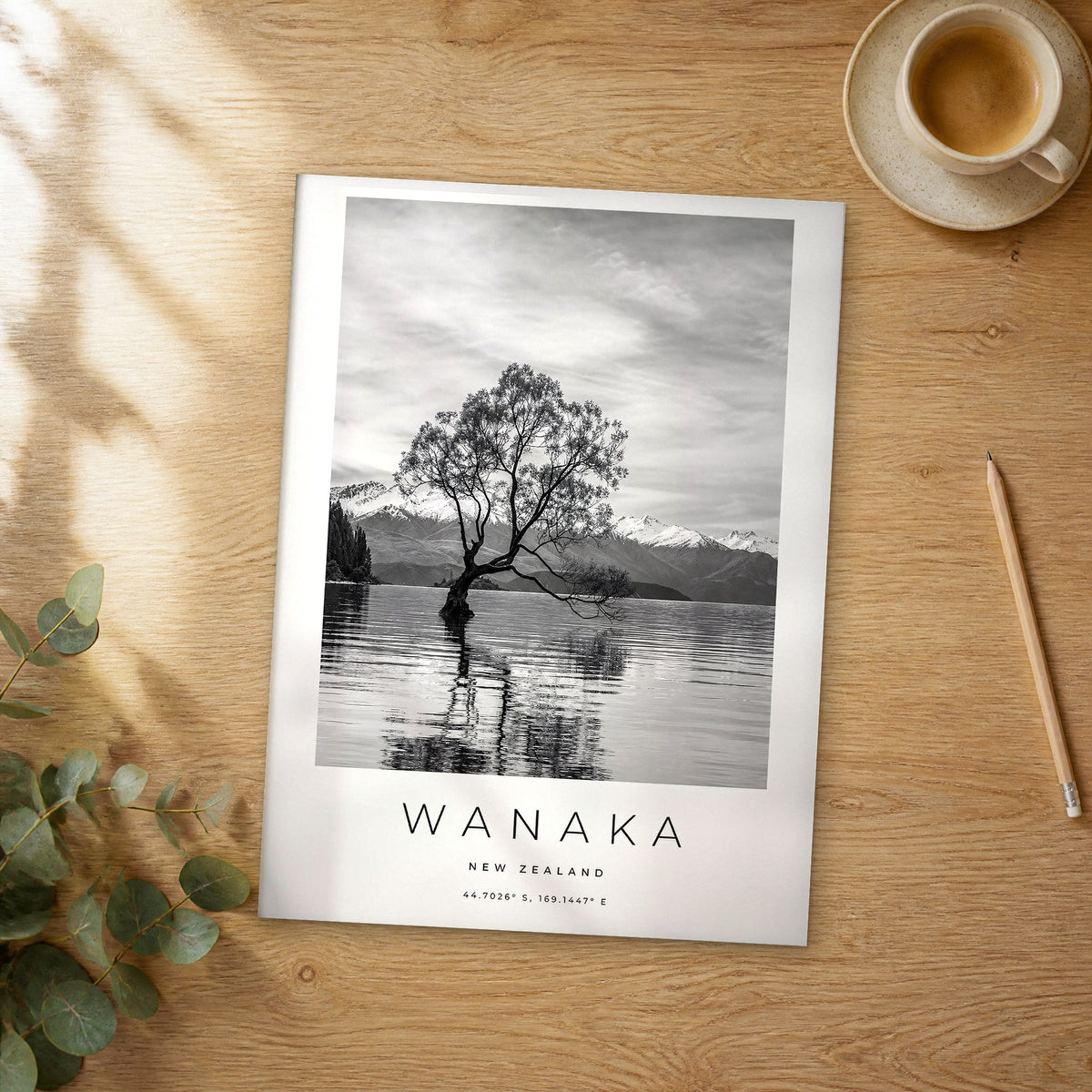 Unframed Wanaka black and white travel poster on a wooden table