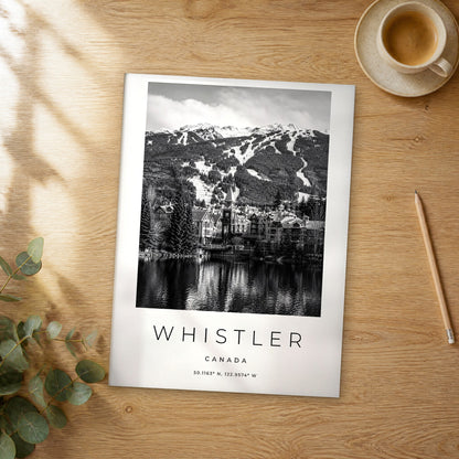 Unframed Whistler black and white travel poster on a wooden table