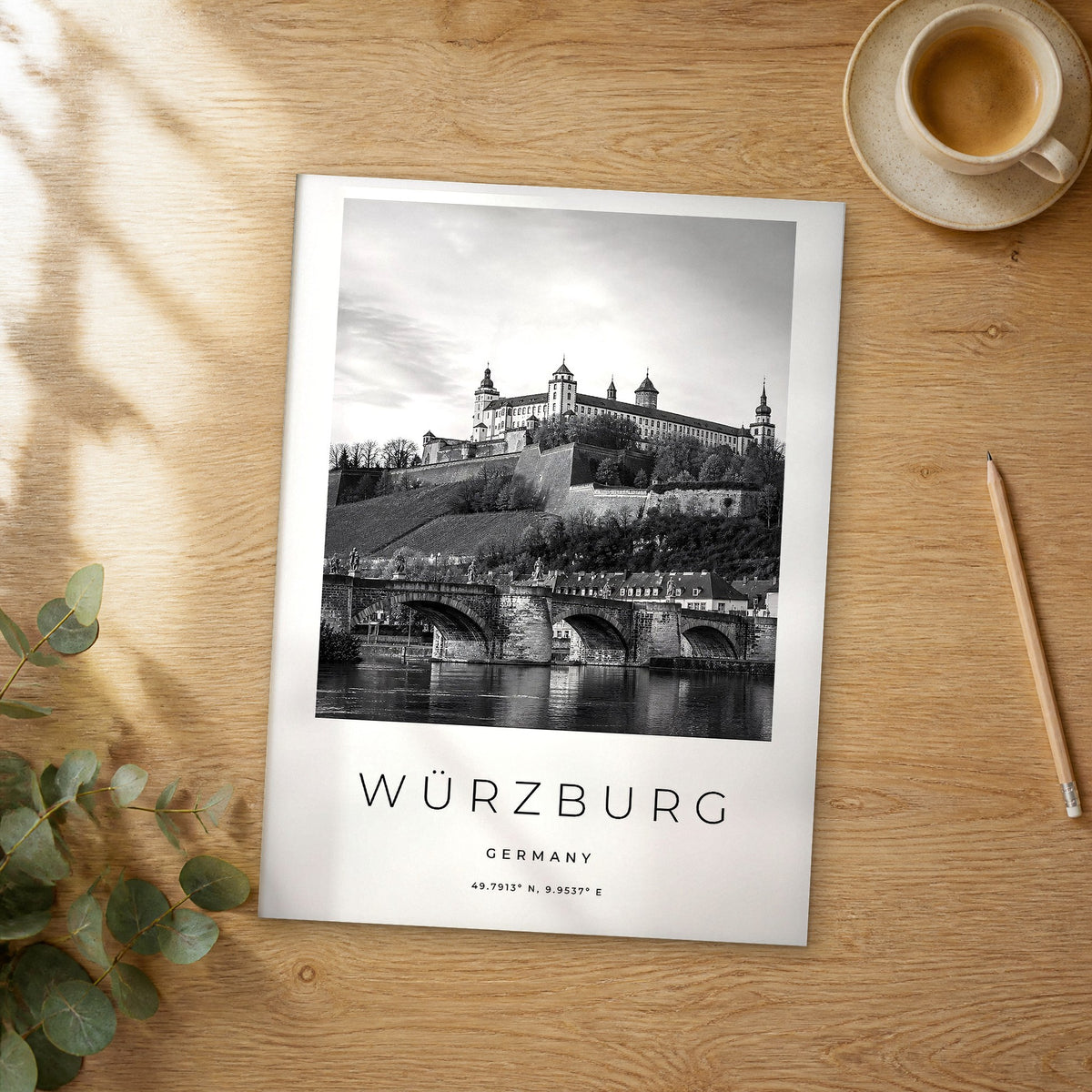 Unframed Würzburg black and white travel poster on a wooden table