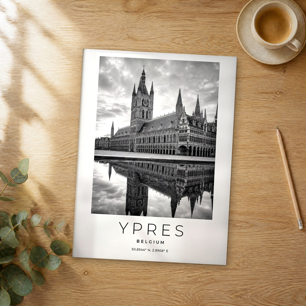 Unframed Ypres black and white travel poster on a wooden table