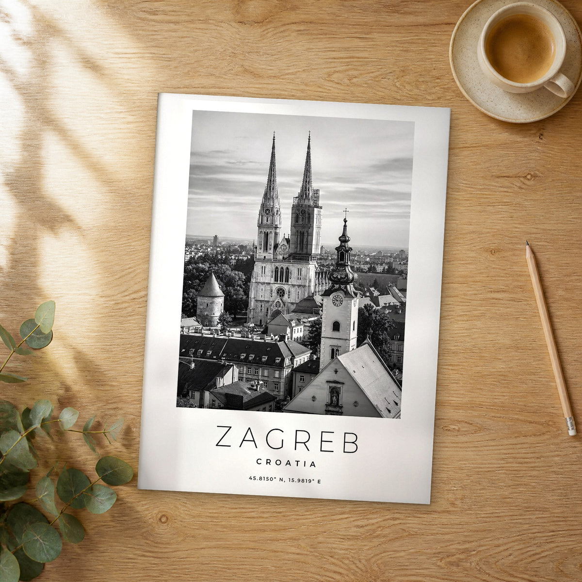 Unframed Zagreb black and white travel poster on a wooden table